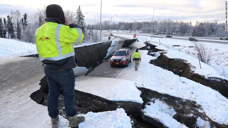 A stranded vehicle on a collapsed roadway near the Anchorage airport after the 7.0 earthquake. 