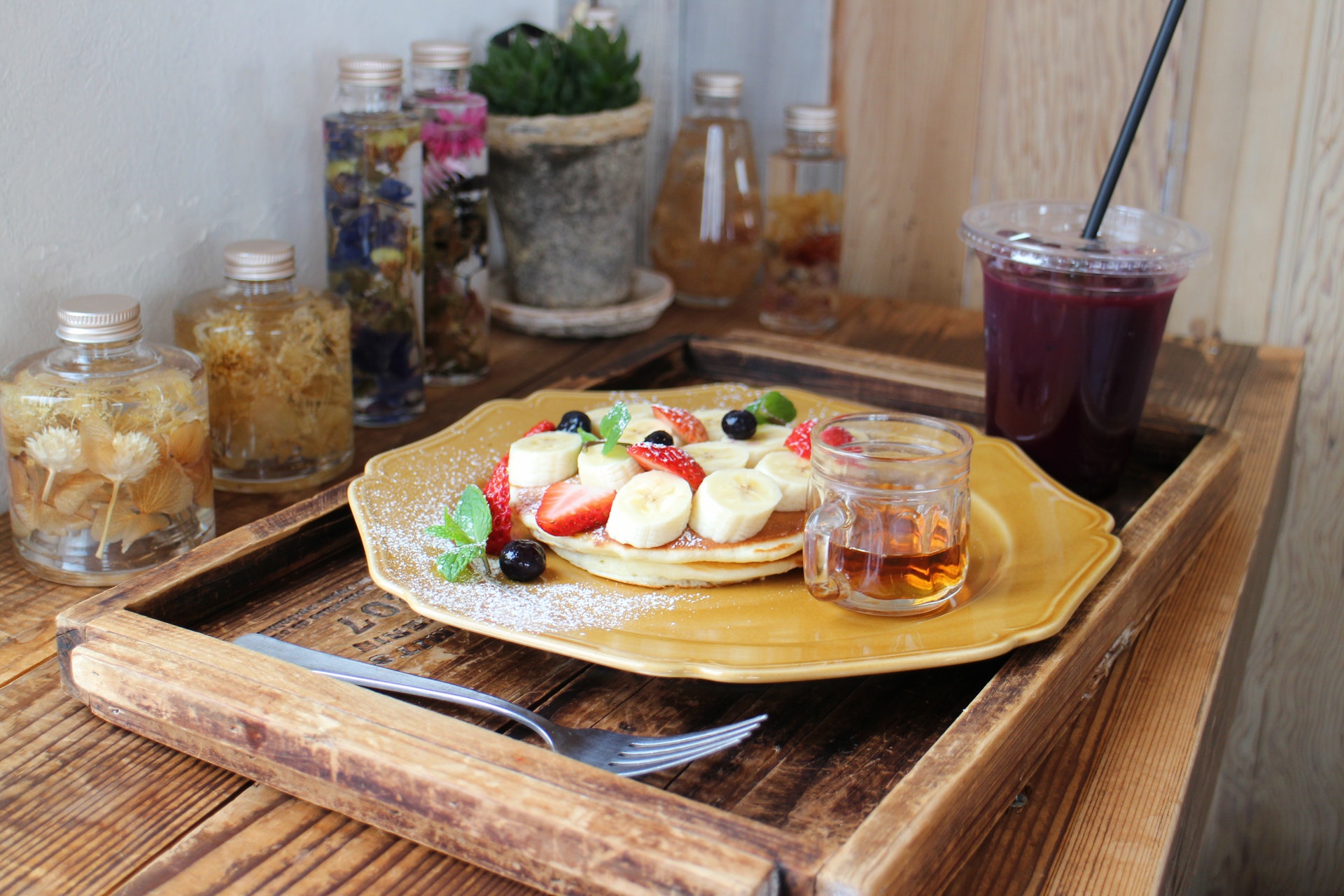 pancakes-garnished-with-fruits-next-to-a-cup-of-juice-2084706.jpg
