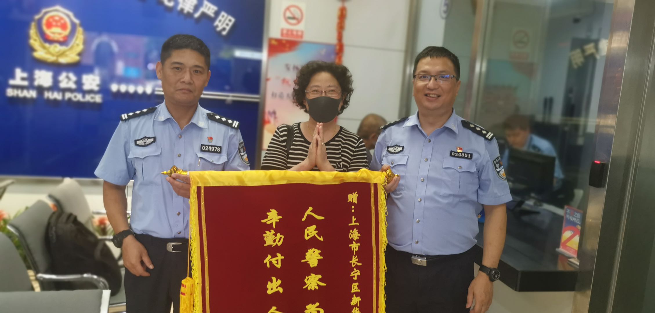 拿回手机后,向民警赠送锦旗.jpg 拿回手机后,向民警赠送锦旗.jpg
